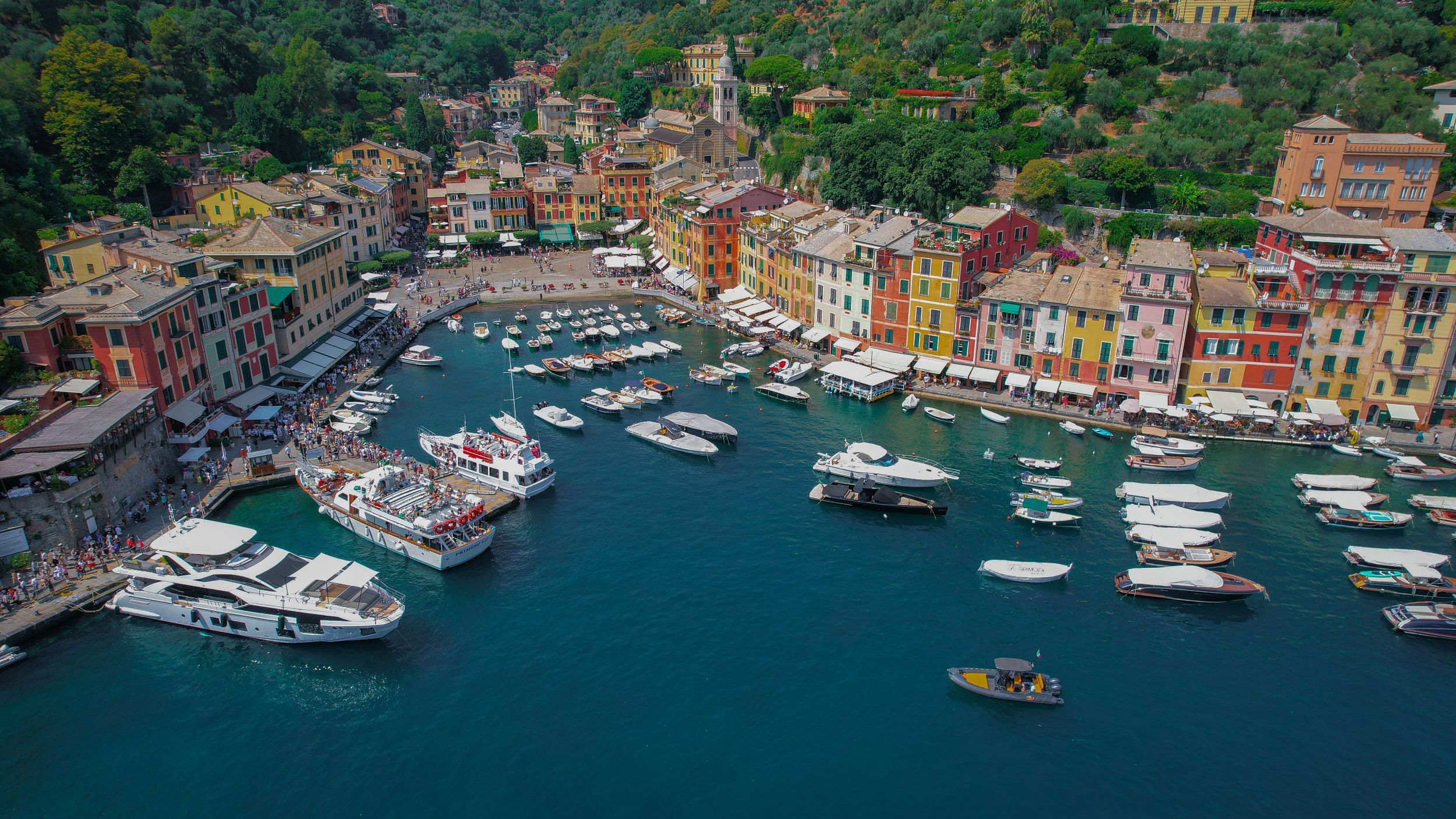 Portofino harbour with yachts moored in a compact historic waterfront setting.