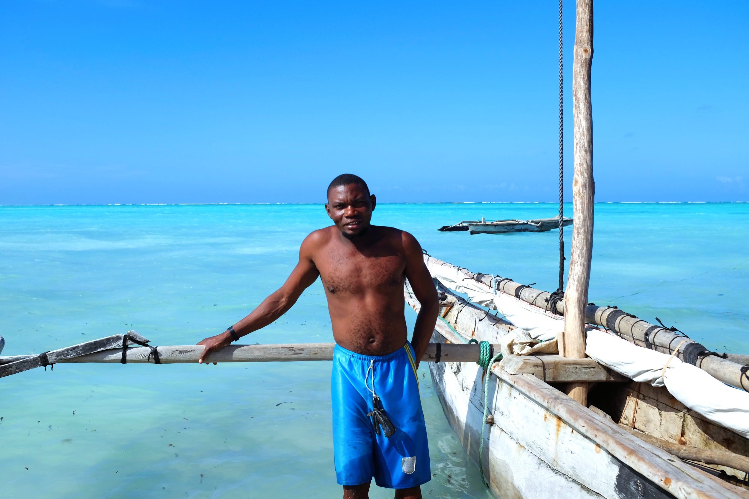 A man beside his boat on the coast of Zanzibar. © EHBLX